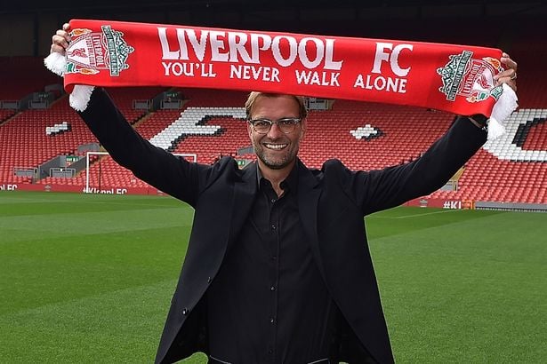 Jurgen Klopp holding Liverpool's scarf